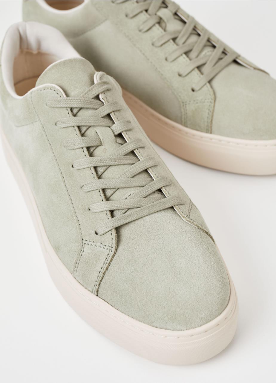 Low-top sneakers in light green suede with tonal lacing and white outsoles. 