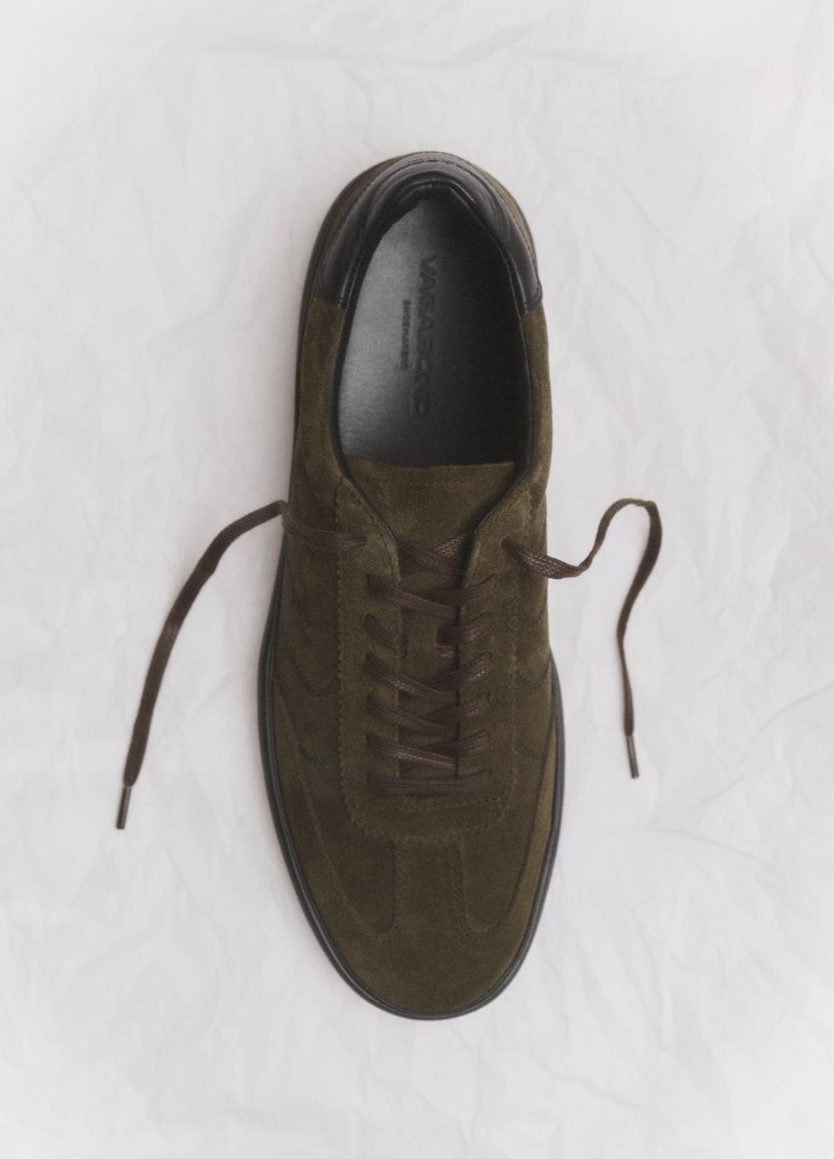 One Leo Sneaker in dark green suede displayed from above on a white surface