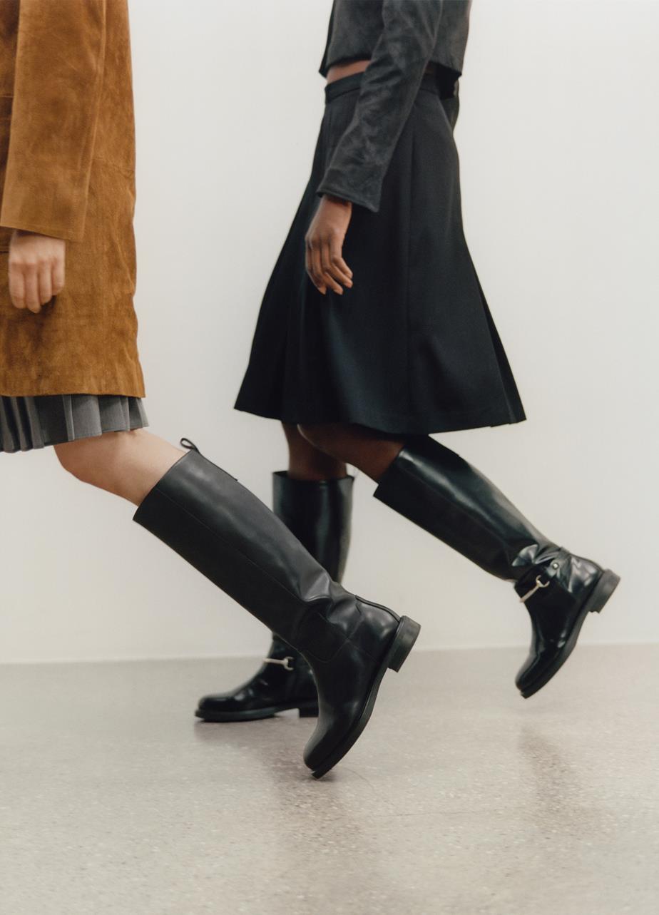 Two people walking, both wearing Freya Tall Boots 