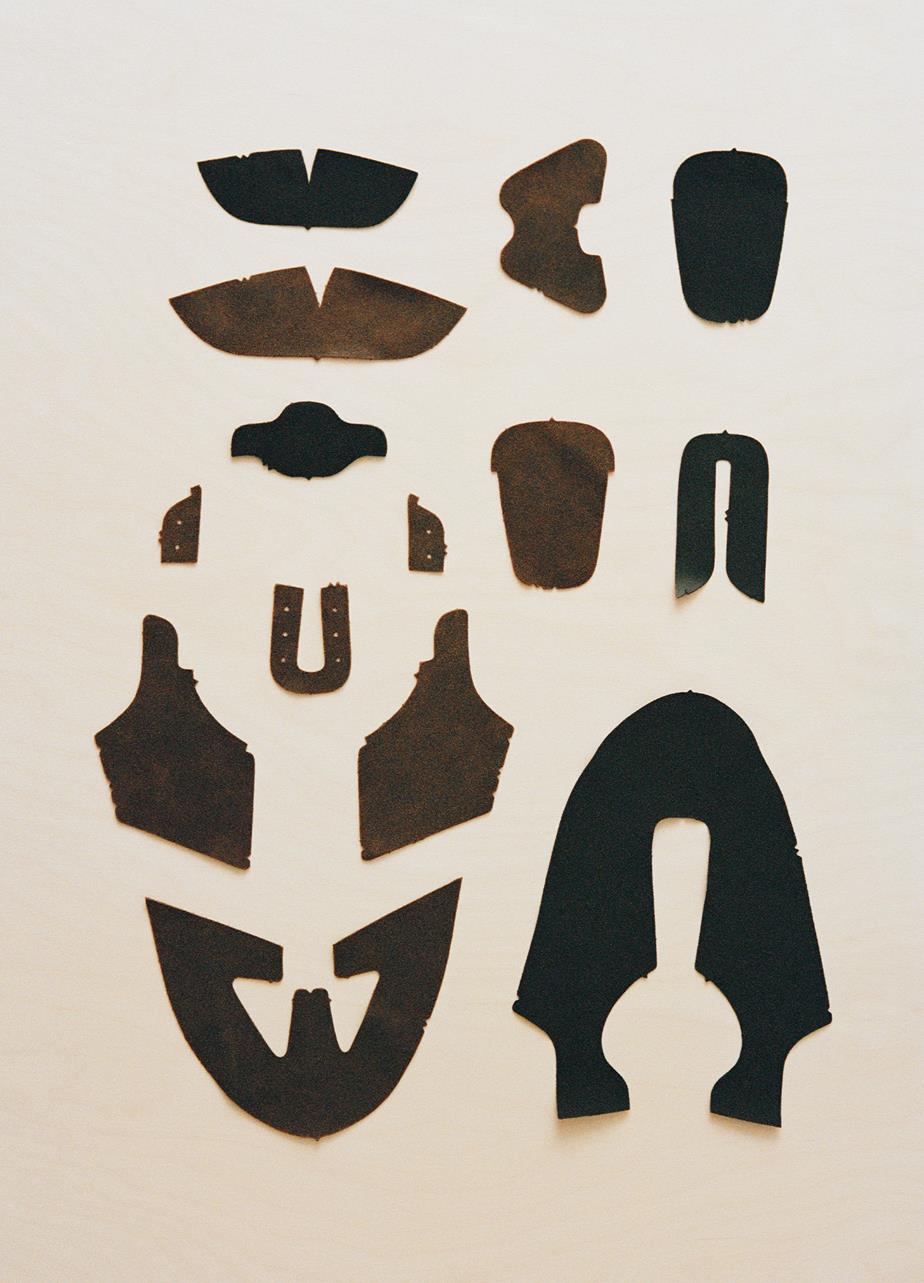 A collection of black and brown leather pieces intended for shoe construction