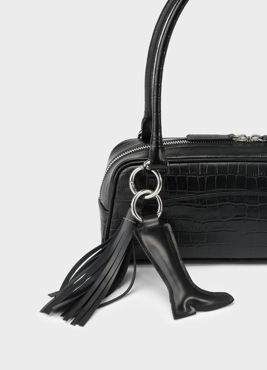 Croc-embossed bag featuring a black leather boot charm and tassel charm.