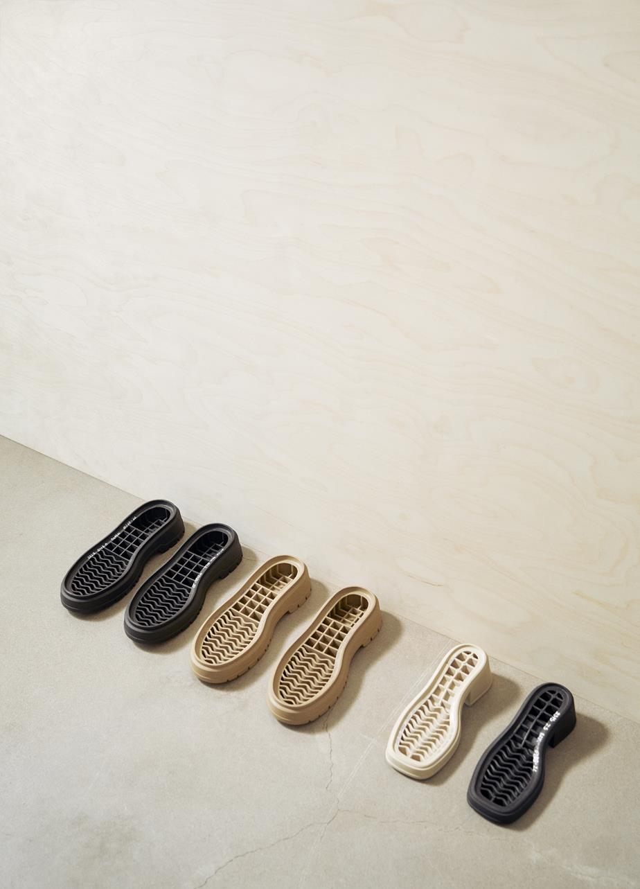 A row of shoes neatly lined up against a wall.