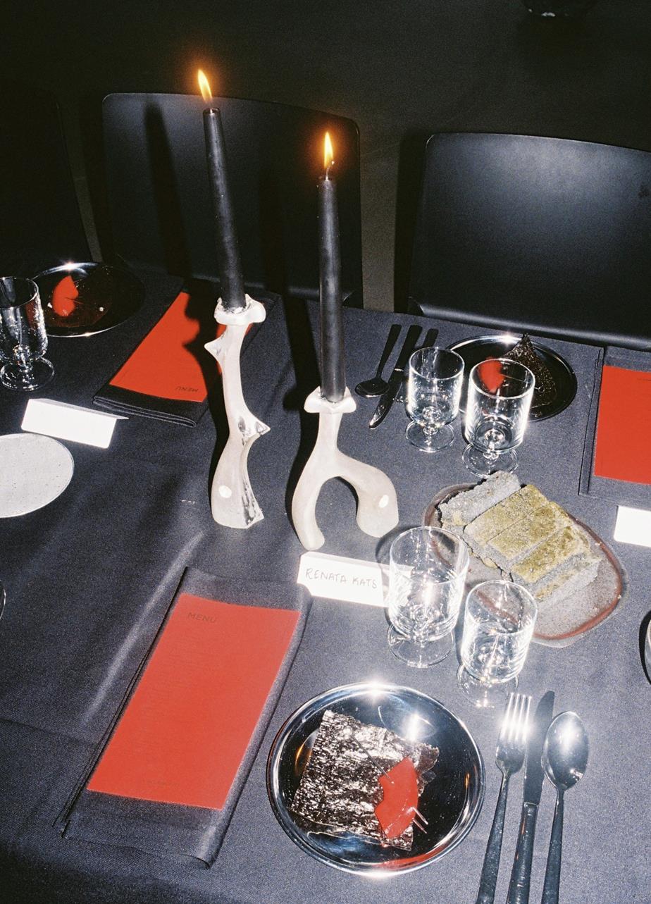 Table setting from the dinner, with bold red and sculptural details.