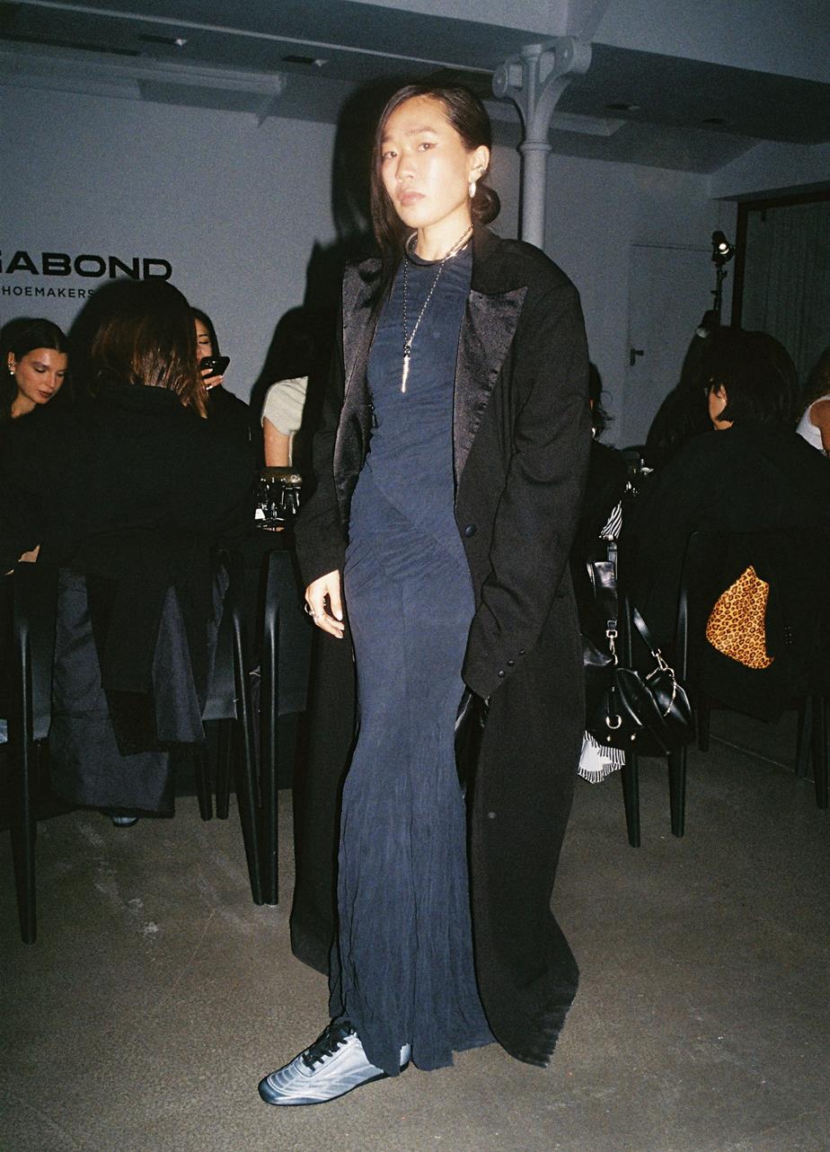 Guest wearing black Hillary Soccer sneakers with a long coat and dress.