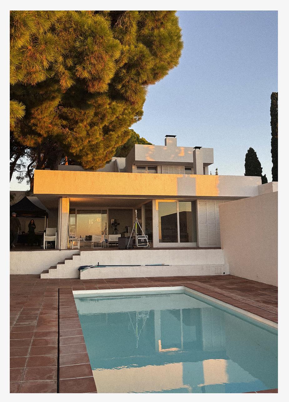 A house with a pool as the sun is setting.