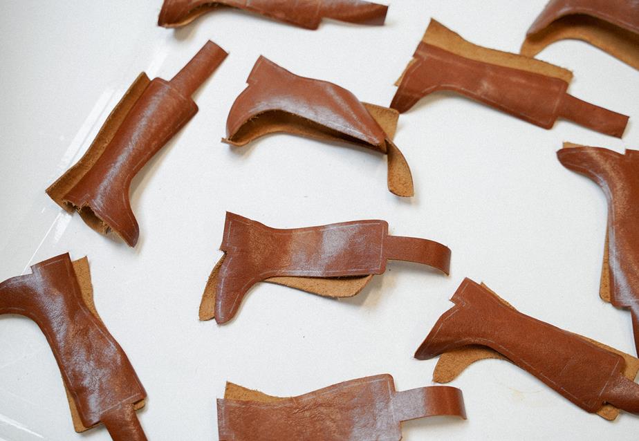 Cuts to be charms, shaped like brown leather boots.